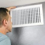Man inspecting HVAC vent