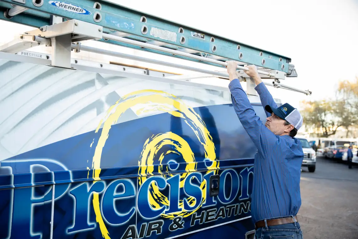 HVAC technician preparing service truck